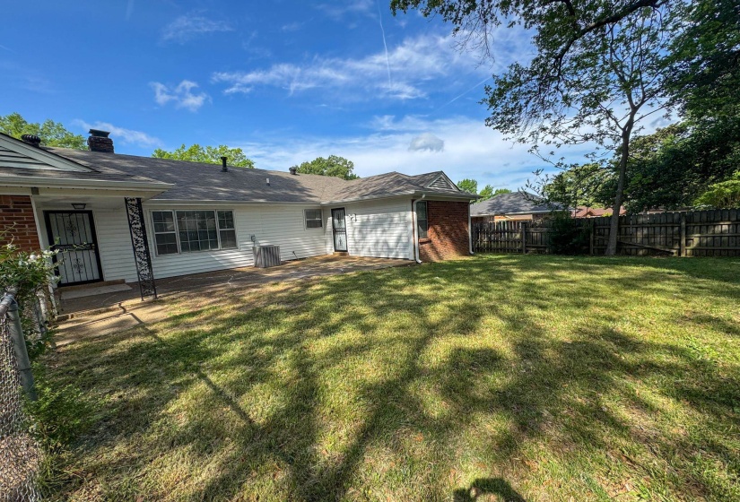 Fenced backyard with a patio