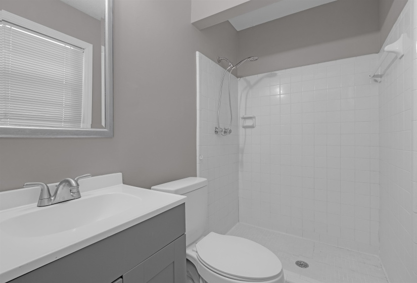 Bathroom with vanity and a stall shower