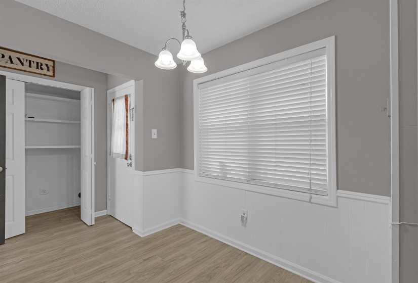 Unfurnished dining area with a chandelier and light wood-type flooring