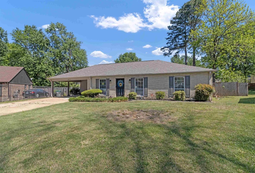 Ranch-style home with brick siding, a carport, and driveway