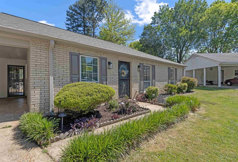 Single story home featuring brick siding, roof with shingles, and a front lawn