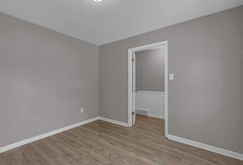 Unfurnished room featuring light wood-style flooring and a textured ceiling