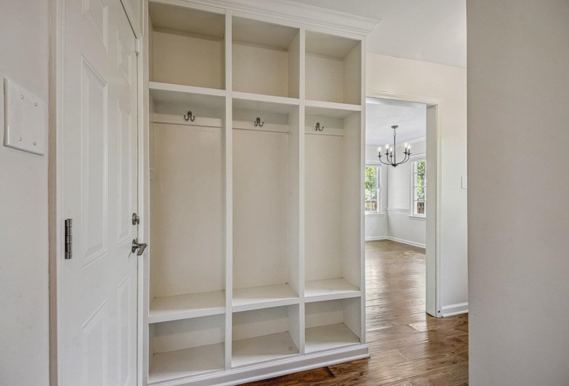 Mudroom featuring hardwood / wood-style flooring and hanging lights