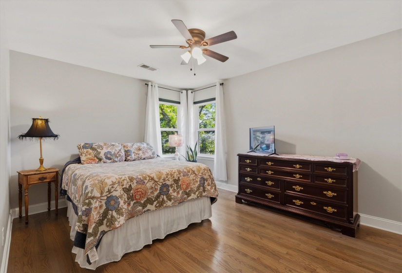 Bedroom with dark wood-style floors and ceiling fan