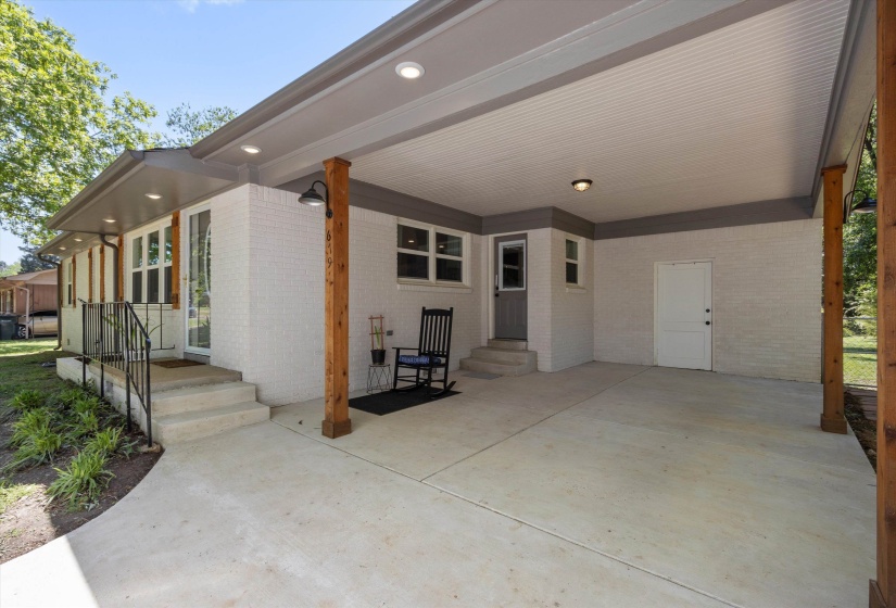 View of patio with entry steps and a carport