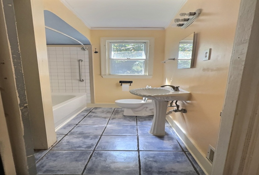 Full bath featuring light tile patterned flooring, bathing tub / shower combination, and crown molding