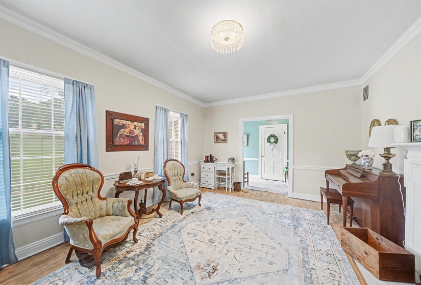 Sitting room featuring light wood-style flooring and ornamental molding