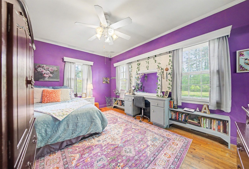 Bedroom featuring a ceiling fan, light wood-style flooring, ornamental molding, and an office area