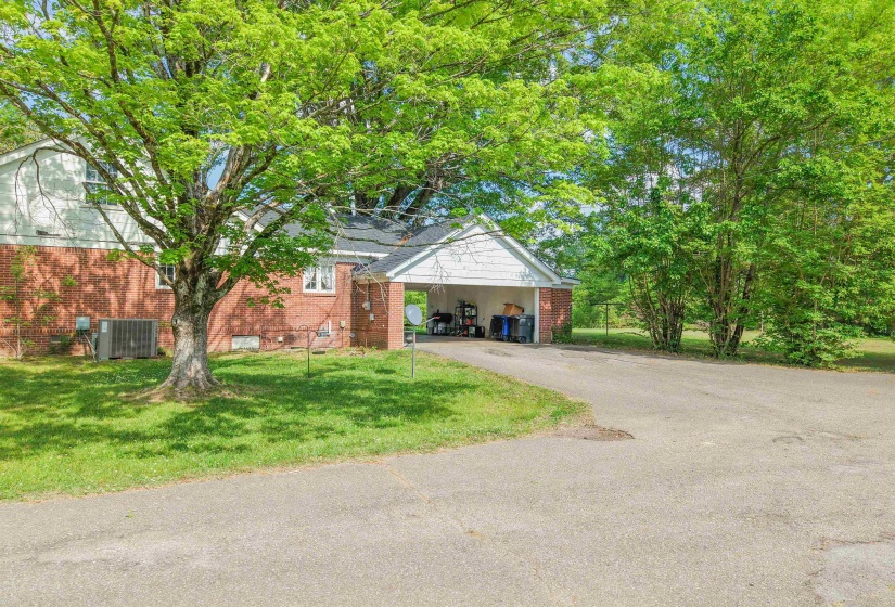 View of front of property with a front lawn, driveway, and brick siding