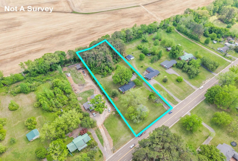 Aerial view of sparsely populated area with property parcel outlined