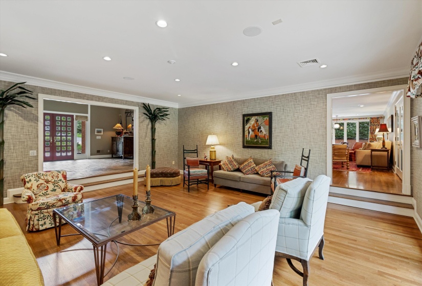 Spacious Living Room Open to Grand Entry with Hardwood, Crown Molding and Access to   Patio and Beautifully Landscaped Rear Grounds