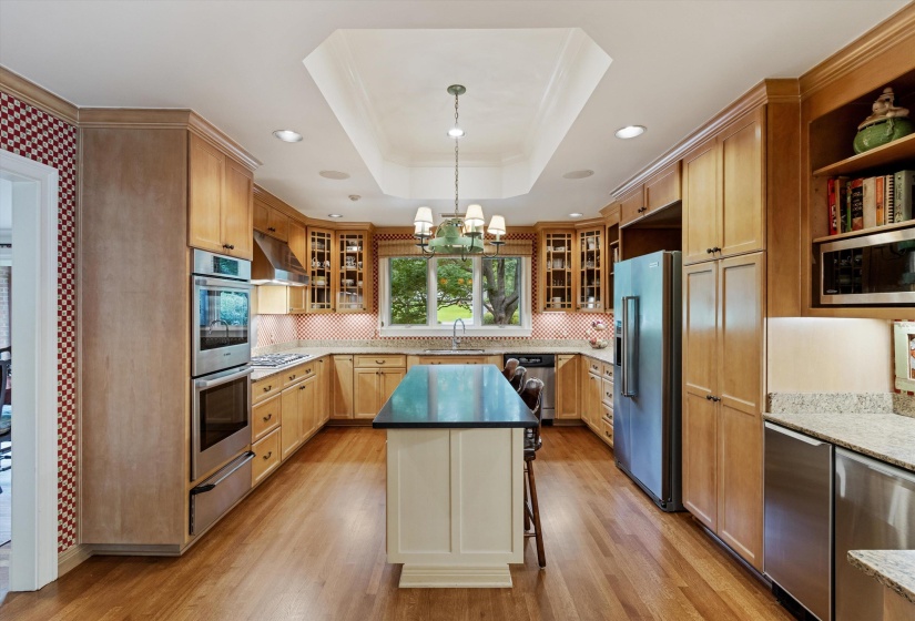 Well-Equipped Gourmet Kitchen Featuring 37 Cabinets, Tray Storage Spice Cabinet, Pantry   Cabinet with Roll-Outs, Built-In Desk, Granite Island, 5-Burner Gas Thermador Range, Double Bosch Ovens   Including Convection, and Warming Drawer.