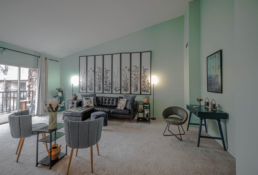 Living room with light carpet and high vaulted ceiling