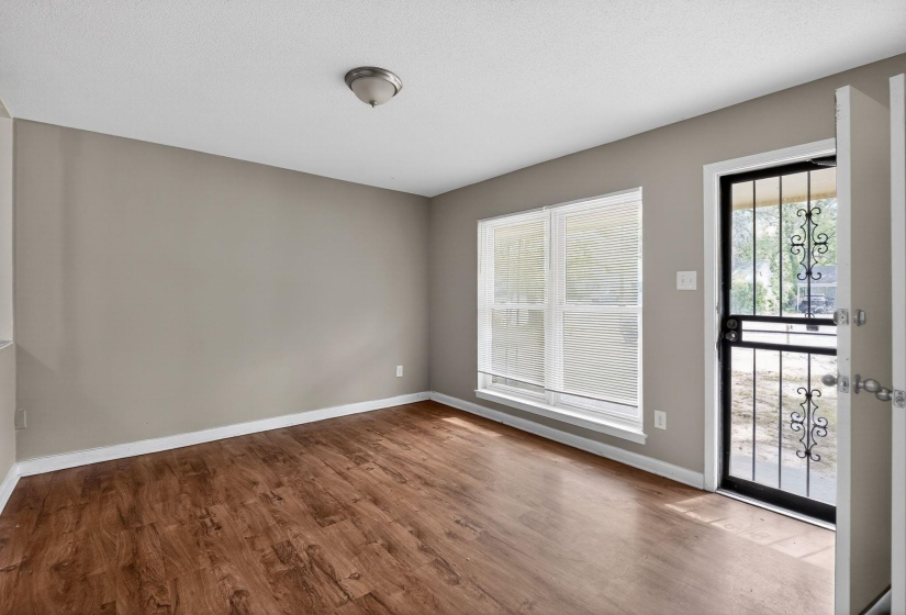 Doorway with wood finished floors and baseboards