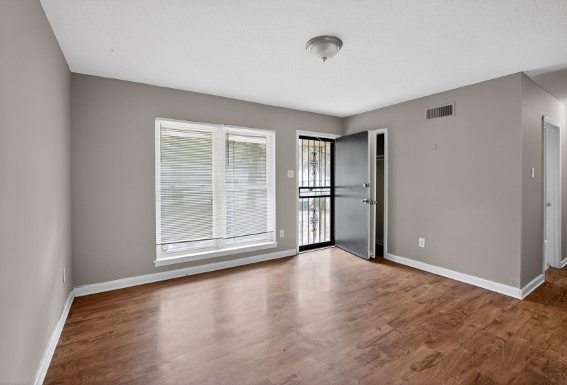 Empty room with dark wood finished floors and baseboards