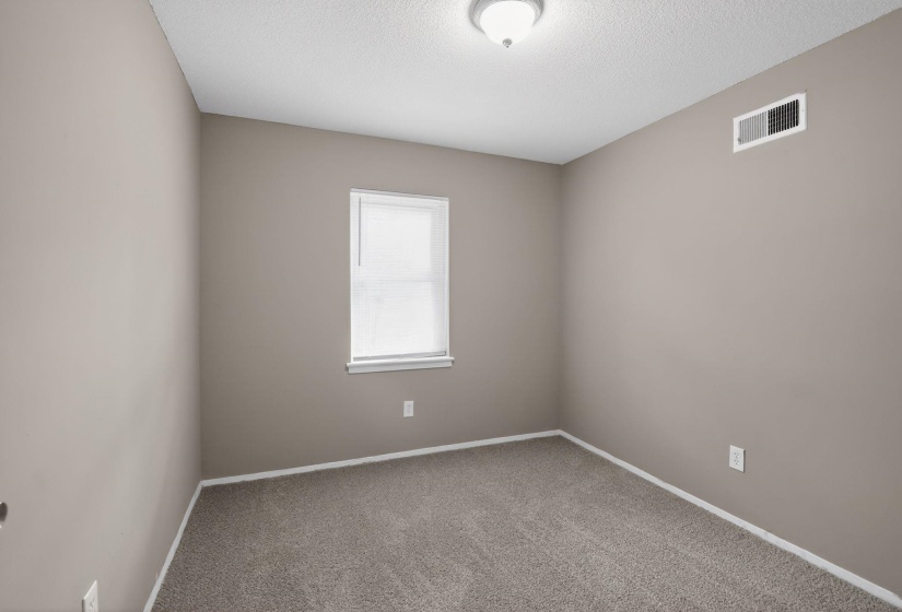 Unfurnished room with carpet flooring and a textured ceiling