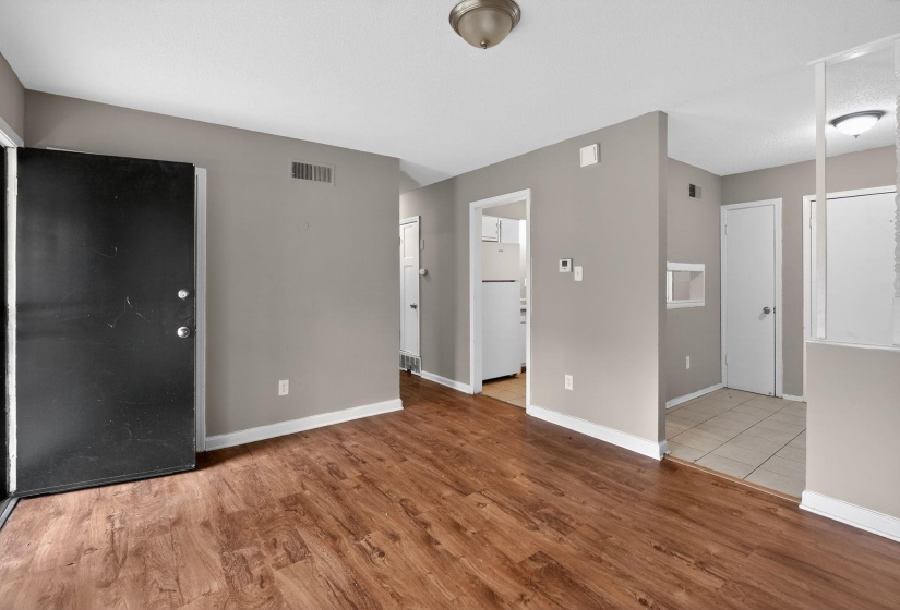 Unfurnished living room with light wood-style floors and baseboards