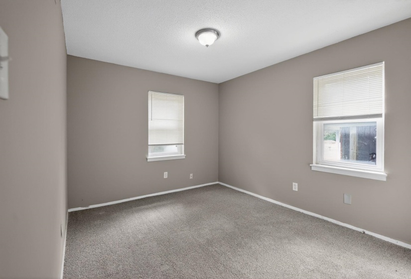 Unfurnished room with carpet and baseboards