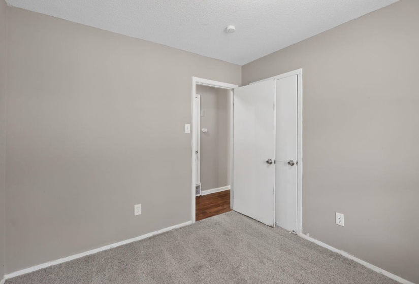 Unfurnished bedroom with carpet floors and a textured ceiling