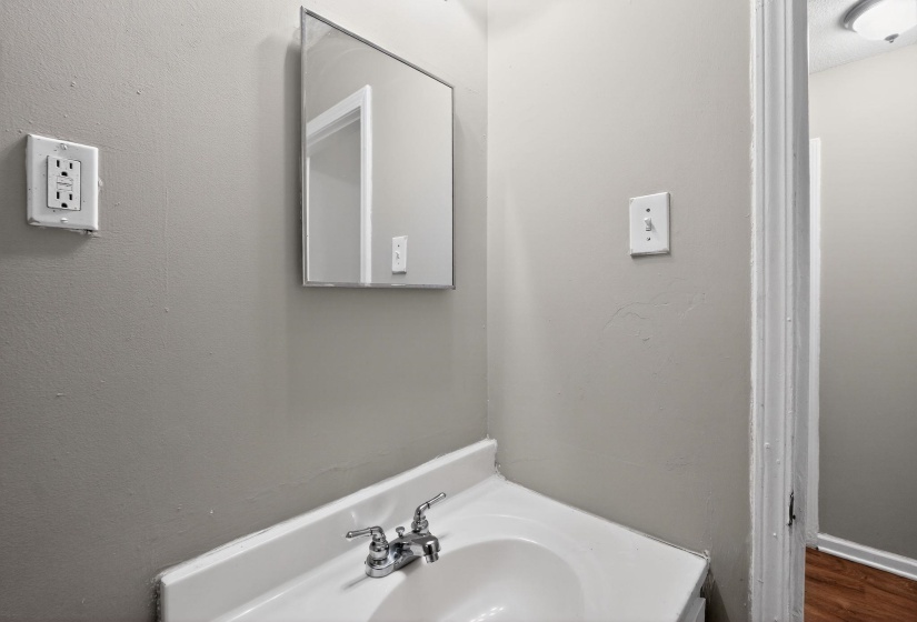 Bathroom with vanity and a textured wall