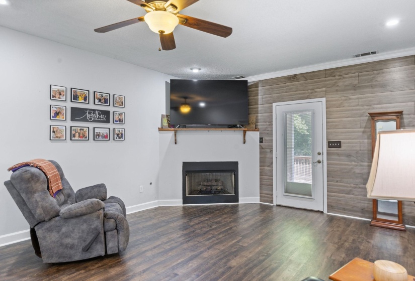 Living area featuring recessed lighting, ceiling fan, dark wood finished floors, and a fireplace