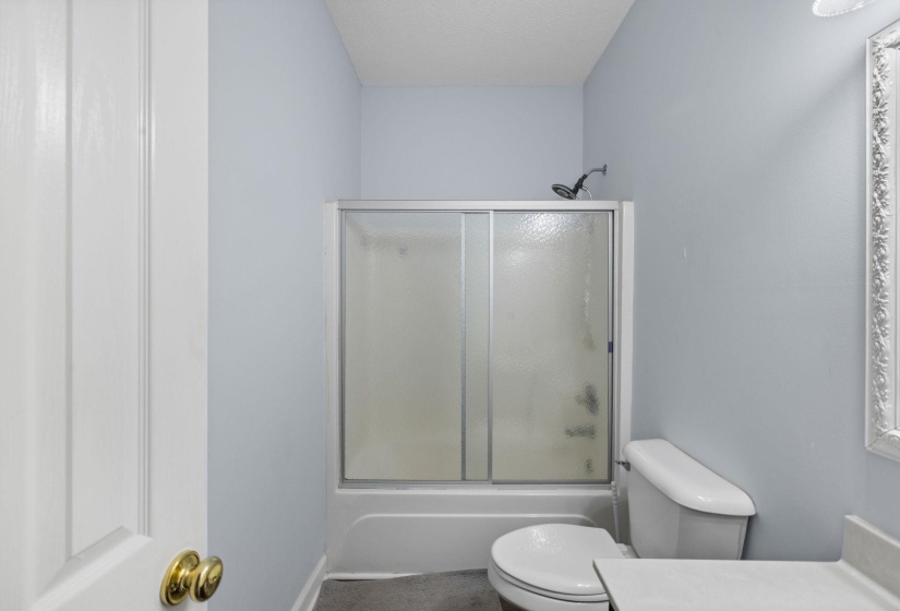 Full bath featuring vanity and enclosed tub / shower combo