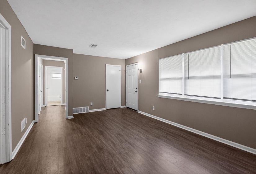 Entryway with baseboards and dark wood-style floors