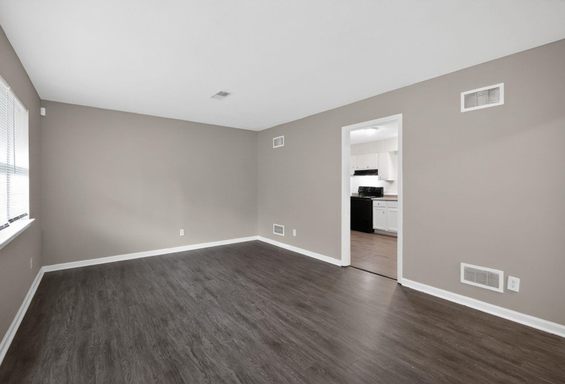 Spare room with dark wood finished floors and baseboards