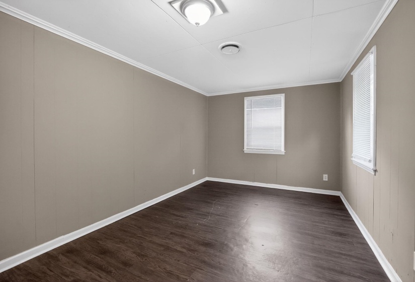 Unfurnished room featuring dark wood finished floors and ornamental molding