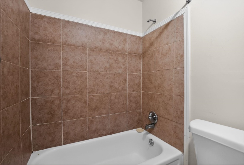 Bathroom featuring toilet and  shower combination