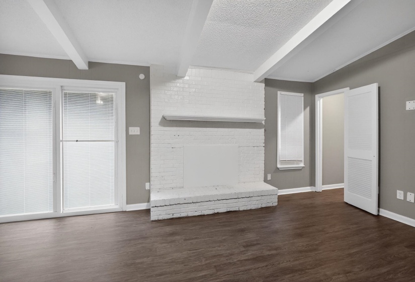 Below grade area featuring a fireplace, dark wood-style floors, and a textured ceiling