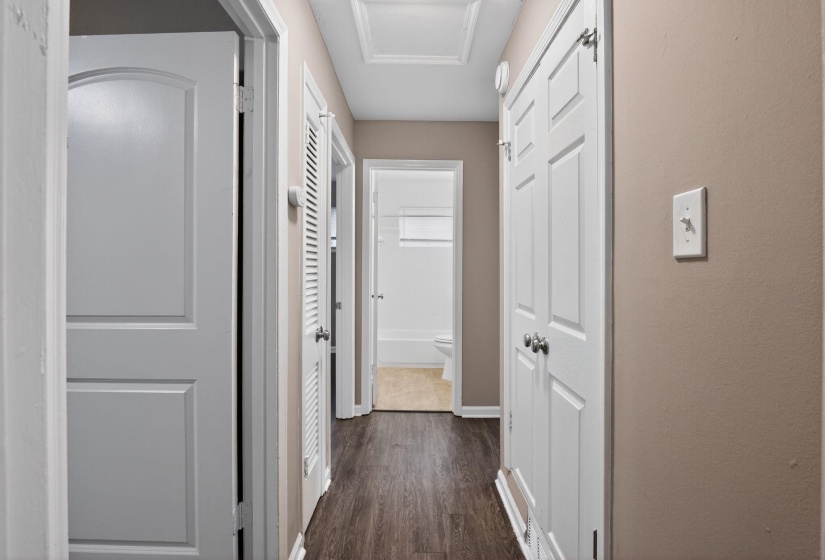 Hall with dark wood finished floors and attic access