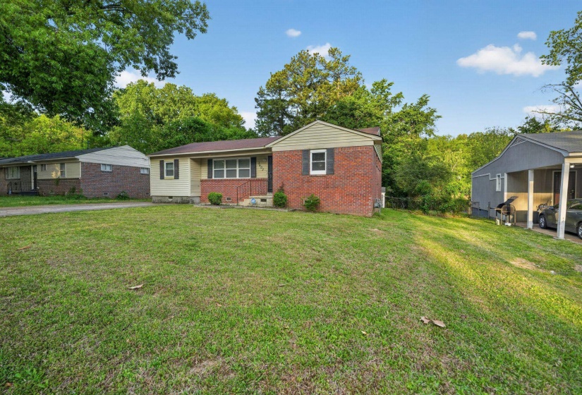 Ranch-style home with crawl space, a front yard, and brick siding