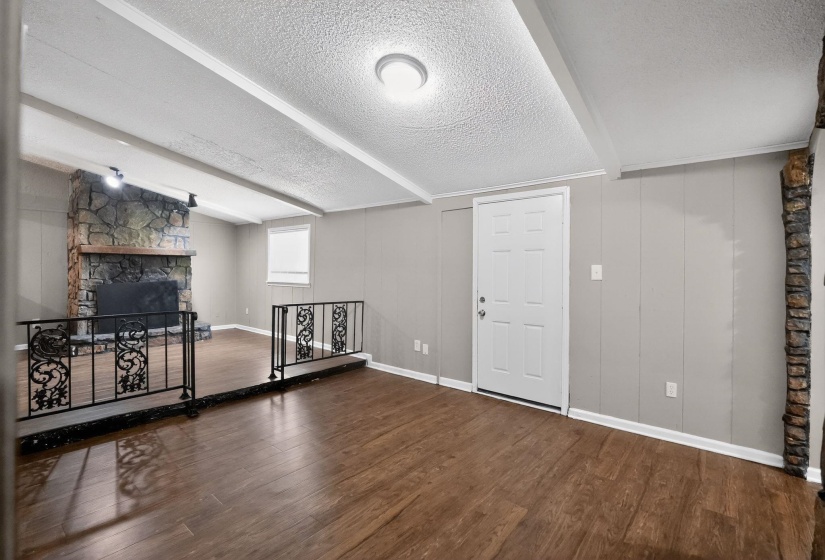 Basement with a fireplace, a textured ceiling, and dark wood-type flooring