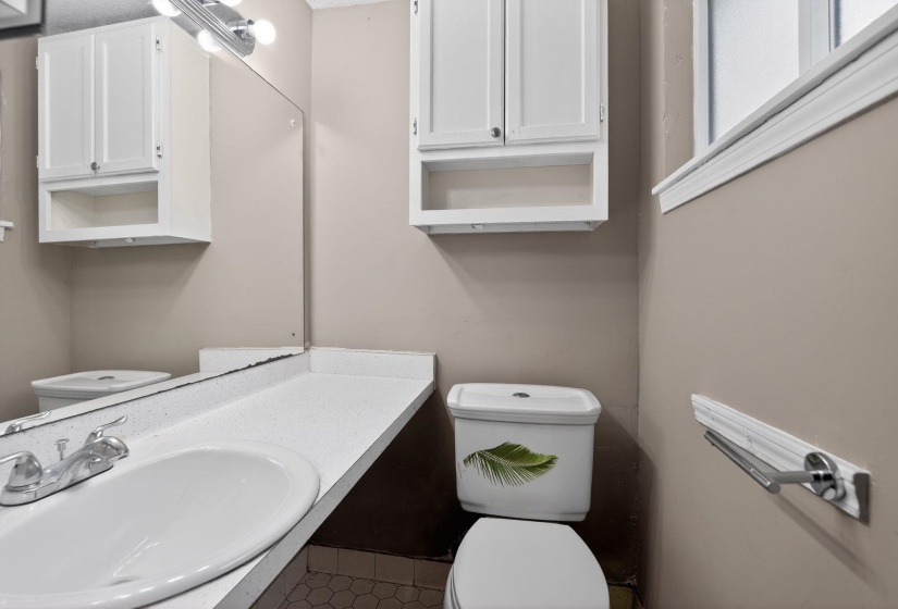 Half bathroom featuring tile patterned flooring and vanity
