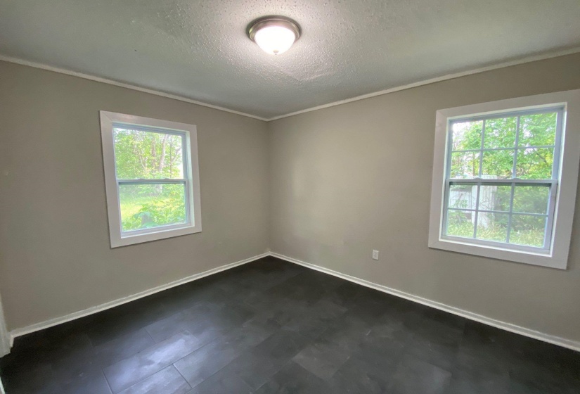 Spare room with a textured ceiling and ornamental molding