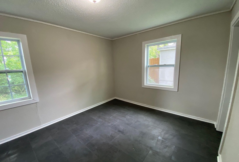 Spare room featuring ornamental molding and a textured ceiling
