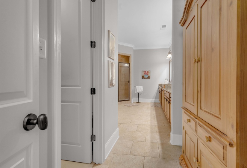 Full bathroom with vanity, ornamental molding, a shower stall, and light tile patterned floors