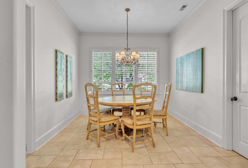Dining room with ornamental molding and hanging lights