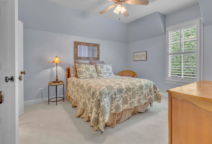 Bedroom featuring light carpet and ceiling fan