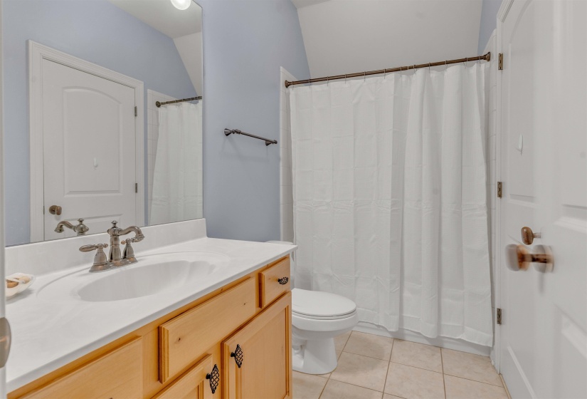 Bathroom featuring vanity, a shower with shower curtain, and light tile patterned floors