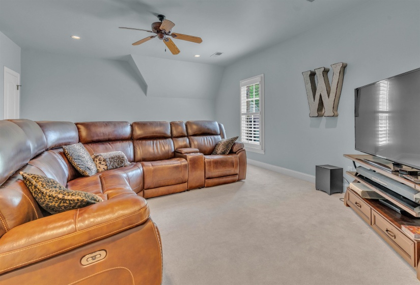 Living area with light carpet, recessed lighting, a ceiling fan, and lofted ceiling