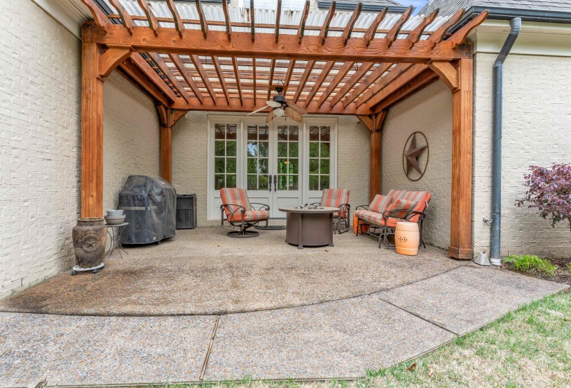 View of patio with a pergola, ceiling fan, area for grilling, and an outdoor living space with a fire pit
