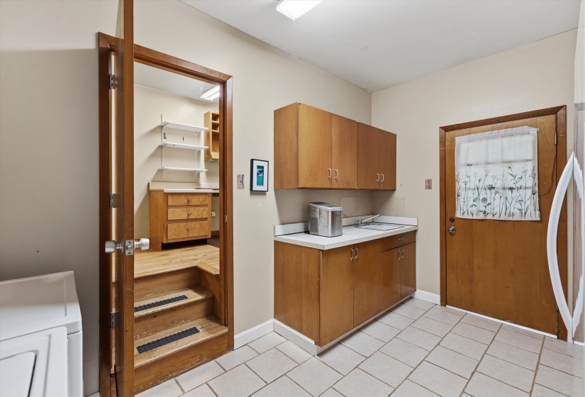 LAUNDRY ROOM (14x09) with tile floor, sink, folding area, 8 cabinets, and exterior door for added convenience. COMPUTER ROOM (11 x 6) with hardwood floor and closet—ideal for work, hobbies, or study.