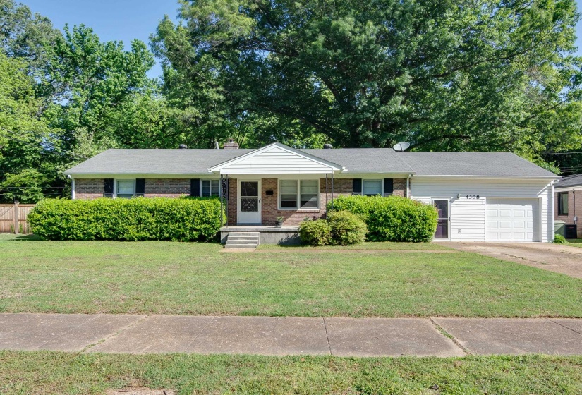 Brick and siding ranch-style home featuring a covered front entry, attached single-car garage, manicured shrubbery, and a concrete driveway