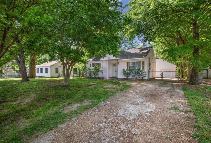 White single-story residence with a gabled roof and light-colored siding