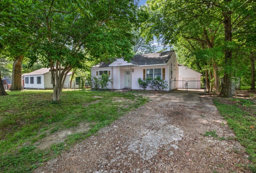Single-story residence featuring light-colored siding, a dark shingle roof, and white-framed windows
