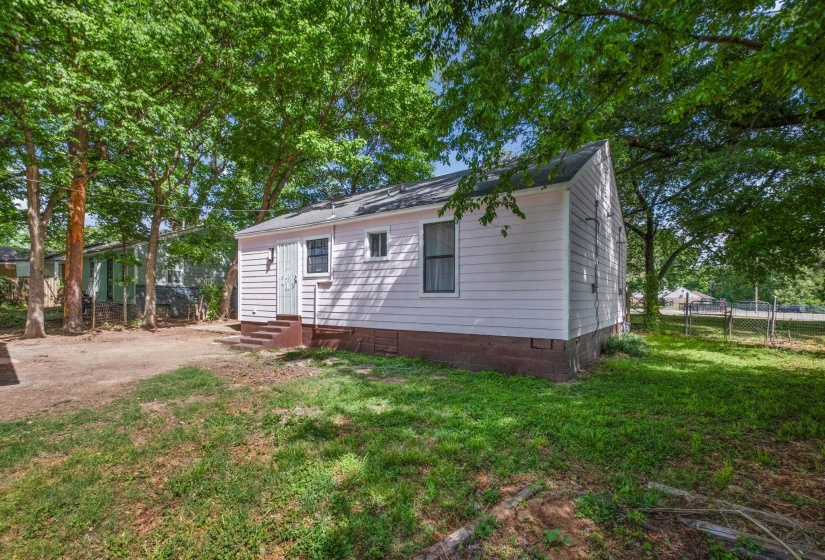 Single-story residence featuring light-colored siding and a dark-colored roof