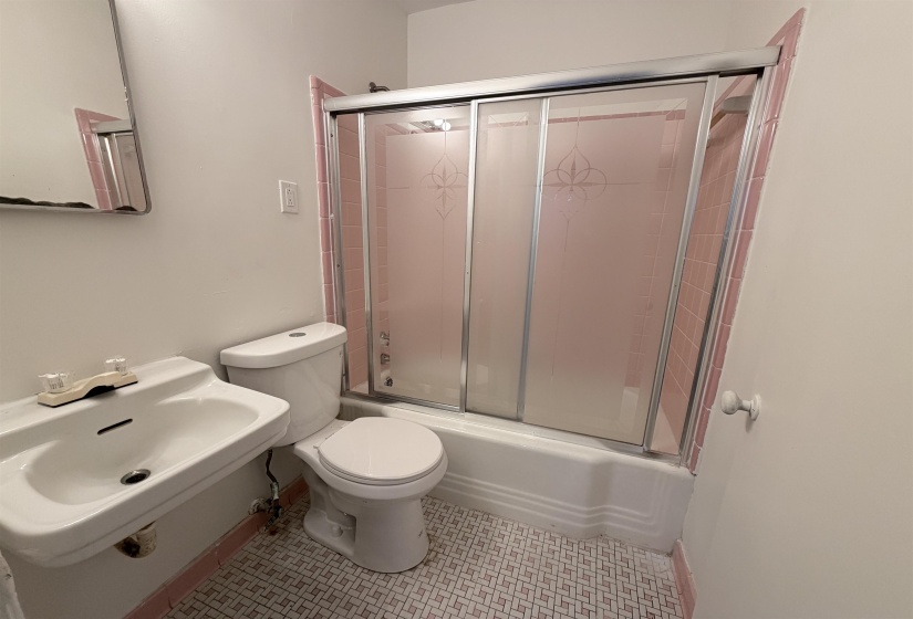 Bathroom featuring shower / bath combination with glass door and toilet