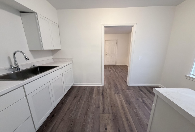 Washroom with a sink and dark wood finished floors